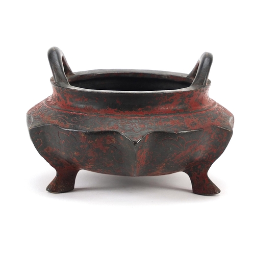 1322 - Chinese red painted bronze tripod censer with twin handles, character marks to the base, 16cm in dia... 