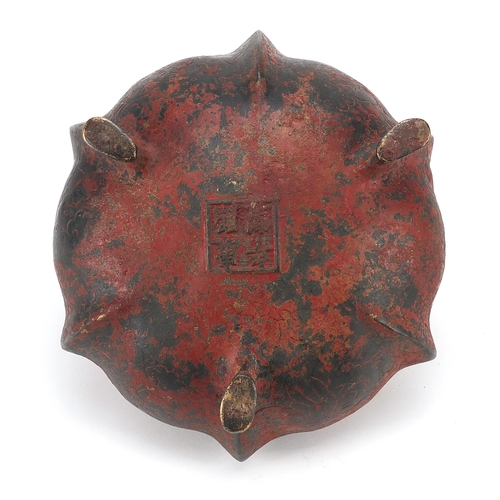 1322 - Chinese red painted bronze tripod censer with twin handles, character marks to the base, 16cm in dia... 