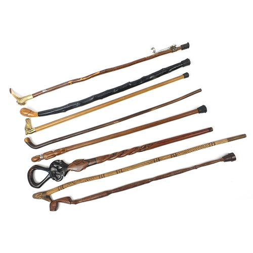 1199 - Eight tribal interest wooden walking sticks including one with antler horn handle, each approximatel... 