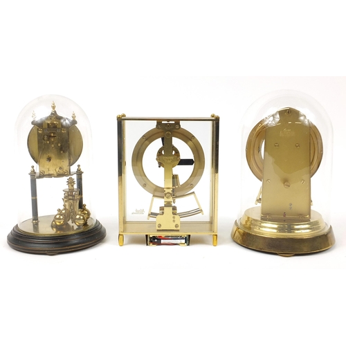 1258 - Two anniversary clocks with glass domes and a Kundo electronic mantle clock, the largest 24.5cm high