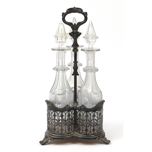 1236 - Three cut glass decanters housed in a silver plated tantalus, 42cm high