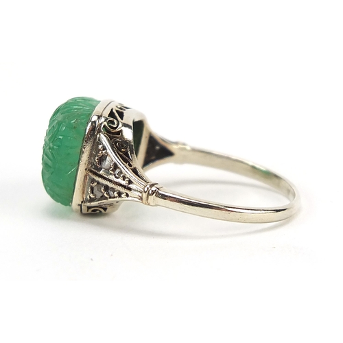 886 - Unmarked white gold carved emerald flower head ring with diamond set shoulders, size Q, 4.7g