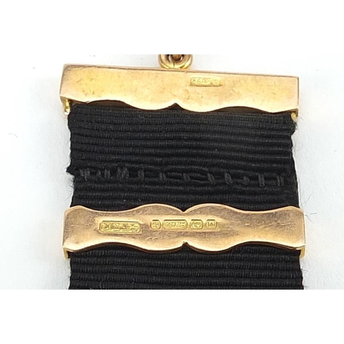 822 - 9ct gold and black onyx masonic fob with gold mounted ribbon, 16.5cm in length, 13.0g