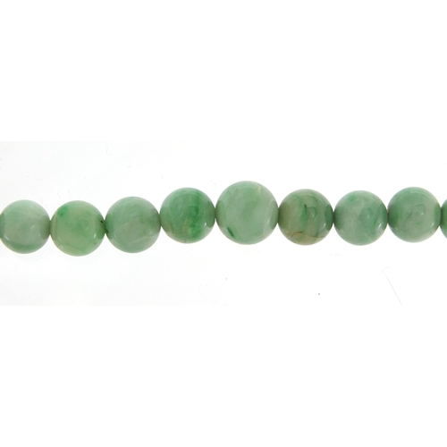 1160 - Chinese graduated green jade bead necklace with gold coloured metal clasp, the largest bead 1cm in d... 