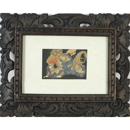 1733 - Figures and dragons, four Balinese watercolours housed in ornate wood frames, the largest approximat... 