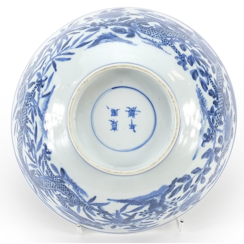 344 - Chinese blue and white porcelain bowl hand painted with a dragon amongst flowers, four figure charac... 