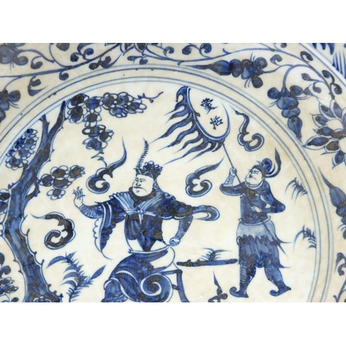 1756 - Large Chinese blue and white porcelain charger hand painted with warriors amongst foliage, character... 