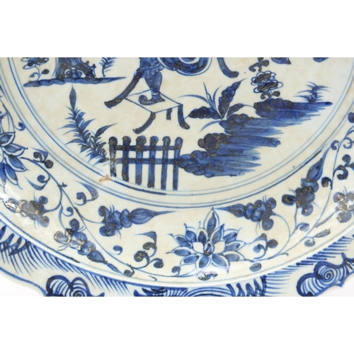 1756 - Large Chinese blue and white porcelain charger hand painted with warriors amongst foliage, character... 