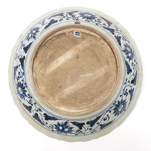 1756 - Large Chinese blue and white porcelain charger hand painted with warriors amongst foliage, character... 