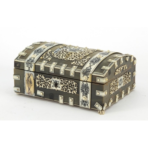 457 - Anglo Indian horn, sandalwood and ivory dome topped casket on paw feet, the ivory penwork panels dec... 