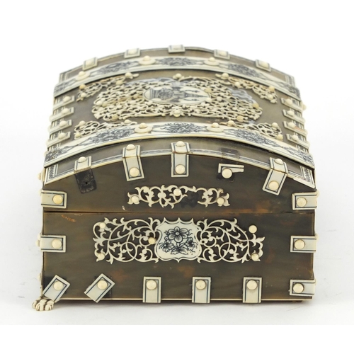 457 - Anglo Indian horn, sandalwood and ivory dome topped casket on paw feet, the ivory penwork panels dec... 