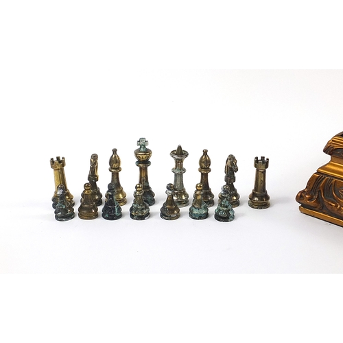 1744 - Ornate gilt framed chess board with metal pieces, the largest pieces each 7cm high