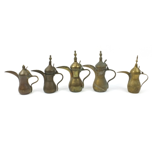 1750 - Five Omani brass dallah coffee pots, the largest 31.5cm high