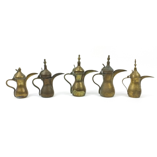 1750 - Five Omani brass dallah coffee pots, the largest 31.5cm high