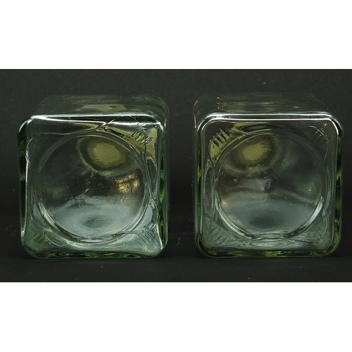 519 - Pair of glass decanters with bronzed rhinoceros and giraffe head stoppers, 24cm high