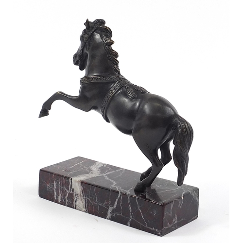 370 - After Minati, patinated bronze rearing horse raised on a marble base, 24cm high