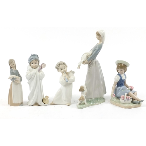 502 - Five Lladro figures including a girl picking flowers and a young girl in a bath robe, the largest 27... 