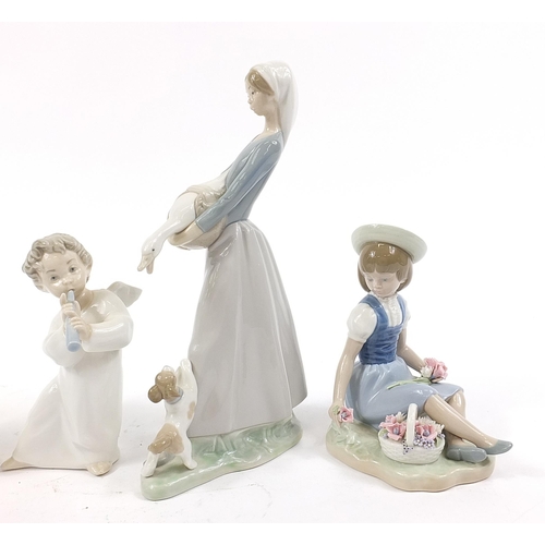 502 - Five Lladro figures including a girl picking flowers and a young girl in a bath robe, the largest 27... 