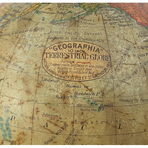 181 - Geographia 10 inch terrestrial table globe raised on a hardwood base with turned column and brass ar... 