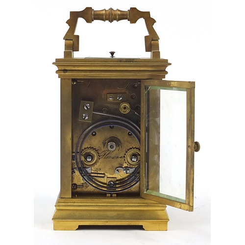 388 - Large brass cased repeating carriage clock striking on a gong with enamel dial having Roman and Arab... 