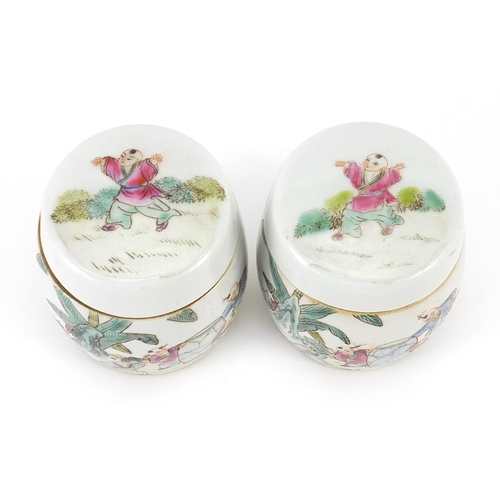 397 - Pair of Chinese porcelain pots and covers hand painted in the famille rose palette with children, ea... 