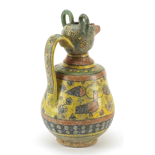 147 - Persian pottery vase in the form of a mythical animal hand painted with birds and flowers, 30cm high