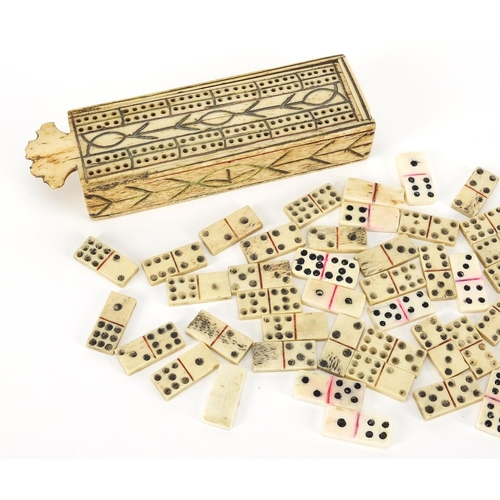 75 - Antique prisoner of war bone dominoes housed in a cribbage board with slide lid, 13cm wide