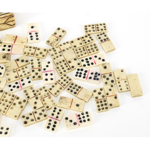 75 - Antique prisoner of war bone dominoes housed in a cribbage board with slide lid, 13cm wide