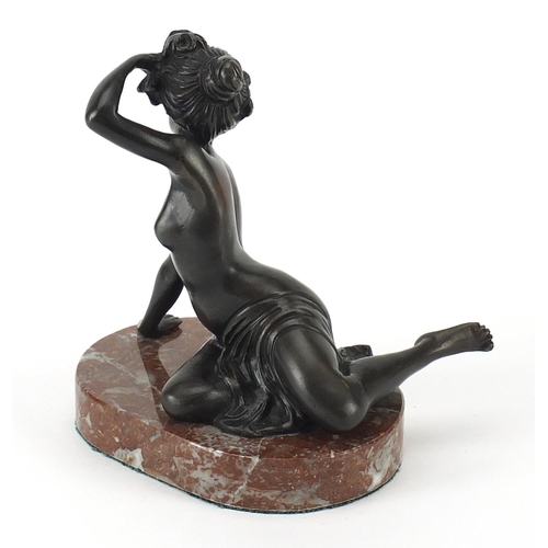 186 - Patinated bronze semi nude figurine raised on a marble base, 14cm high