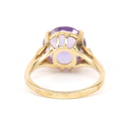 776 - 9ct gold amethyst solitaire ring set with white sapphires to the shoulders, the amethyst 12mm in dia... 