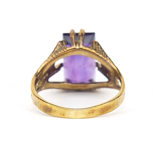 773 - Gold coloured metal purple stone ring, the band stamped 333, size N/O, 3.7g