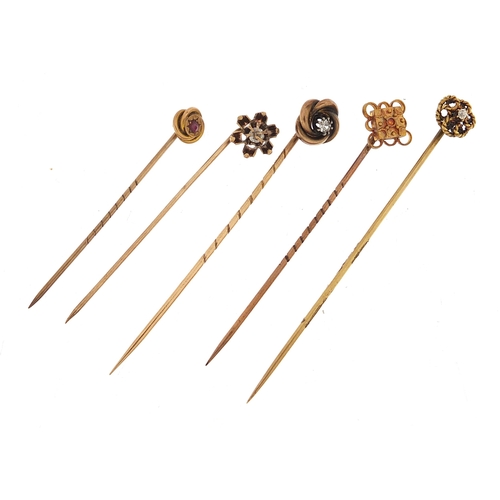 859 - Five Victorian gold stick pins including two diamonds and one with a ruby, the largest 6.8cm in leng... 