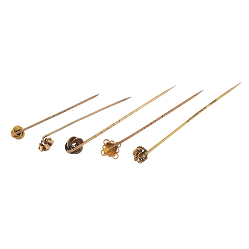 859 - Five Victorian gold stick pins including two diamonds and one with a ruby, the largest 6.8cm in leng... 