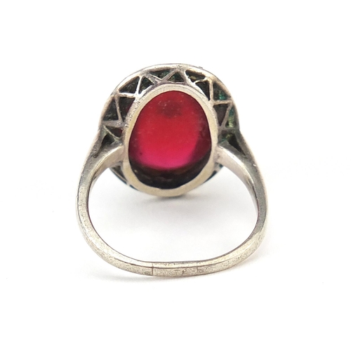 1142 - Antique unmarked silver marcasite ring set with a cabochon red stone and central seed pearl, size Q,... 