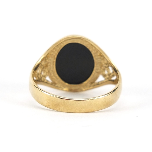 798 - 9ct gold black onyx signet ring with pierced shoulders, size V, 4.3g