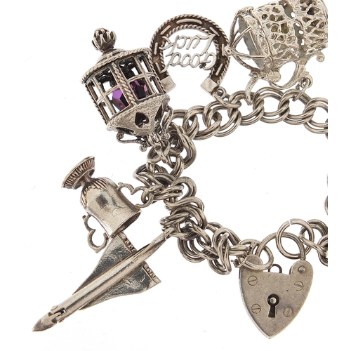 1051 - Silver charm bracelet with a selection of mostly silver charms including Concorde, 16cm in length, 4... 