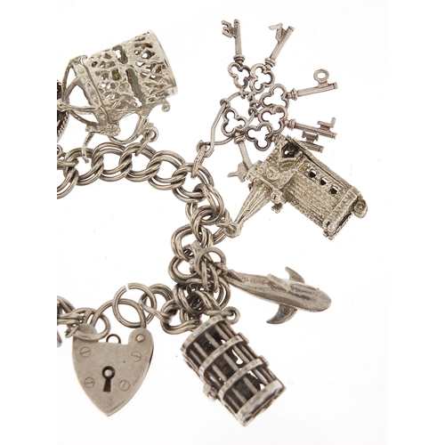 1051 - Silver charm bracelet with a selection of mostly silver charms including Concorde, 16cm in length, 4... 