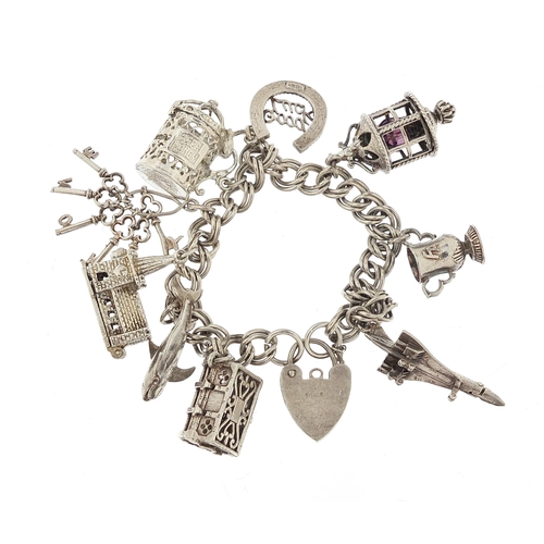 1051 - Silver charm bracelet with a selection of mostly silver charms including Concorde, 16cm in length, 4... 