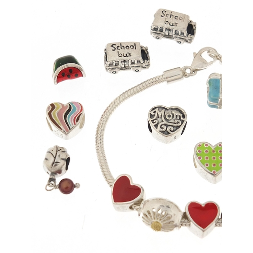 1090 - Pandora design silver charm bracelet with a selection of silver charms, some enamel, the bracelet 21... 