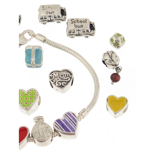 1090 - Pandora design silver charm bracelet with a selection of silver charms, some enamel, the bracelet 21... 