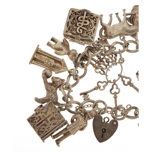 1148 - Silver charm bracelet with a large selection of mostly silver charms including Concorde, 84.8g