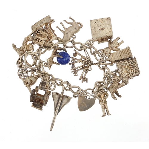 1148 - Silver charm bracelet with a large selection of mostly silver charms including Concorde, 84.8g