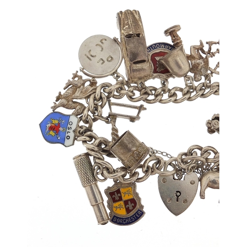 1066 - Silver charm bracelet with a selection of mostly silver charms, 56.8g