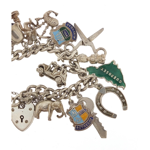 1066 - Silver charm bracelet with a selection of mostly silver charms, 56.8g