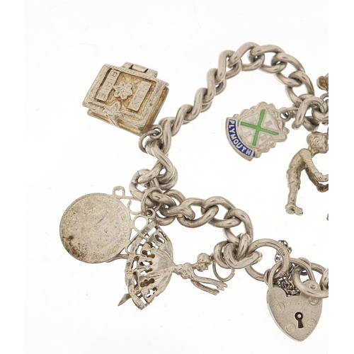 1044 - Silver charm bracelet with a selection of mostly silver charms, 56.8g