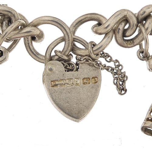 1044 - Silver charm bracelet with a selection of mostly silver charms, 56.8g