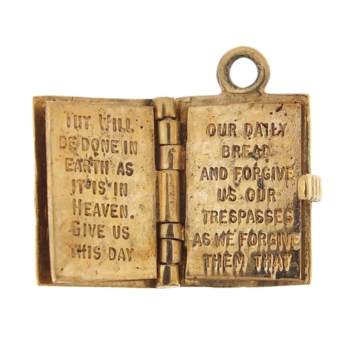 1180 - 9ct gold opening bible charm, 1.2cm high, 3.6g