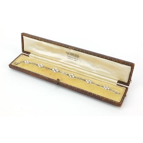 808 - 9ct white gold pearl bracelet housed in an R S Harrison & Son fitted box, 18cm in length, 3.0g