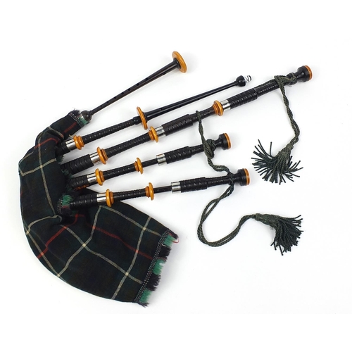 698 - Set of Scottish bagpipes with pipe bag, some pieces stamped R G Hardi