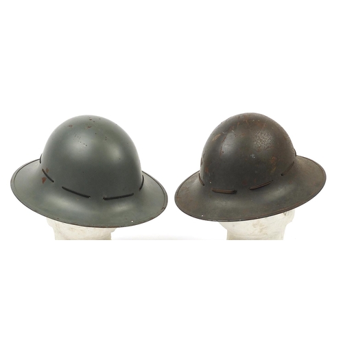 612 - Two British military interest Zuckerman Civil Defence helmets